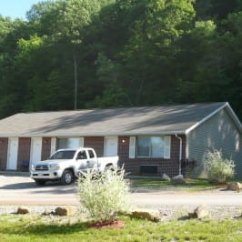 far shot of a pickup truck and house